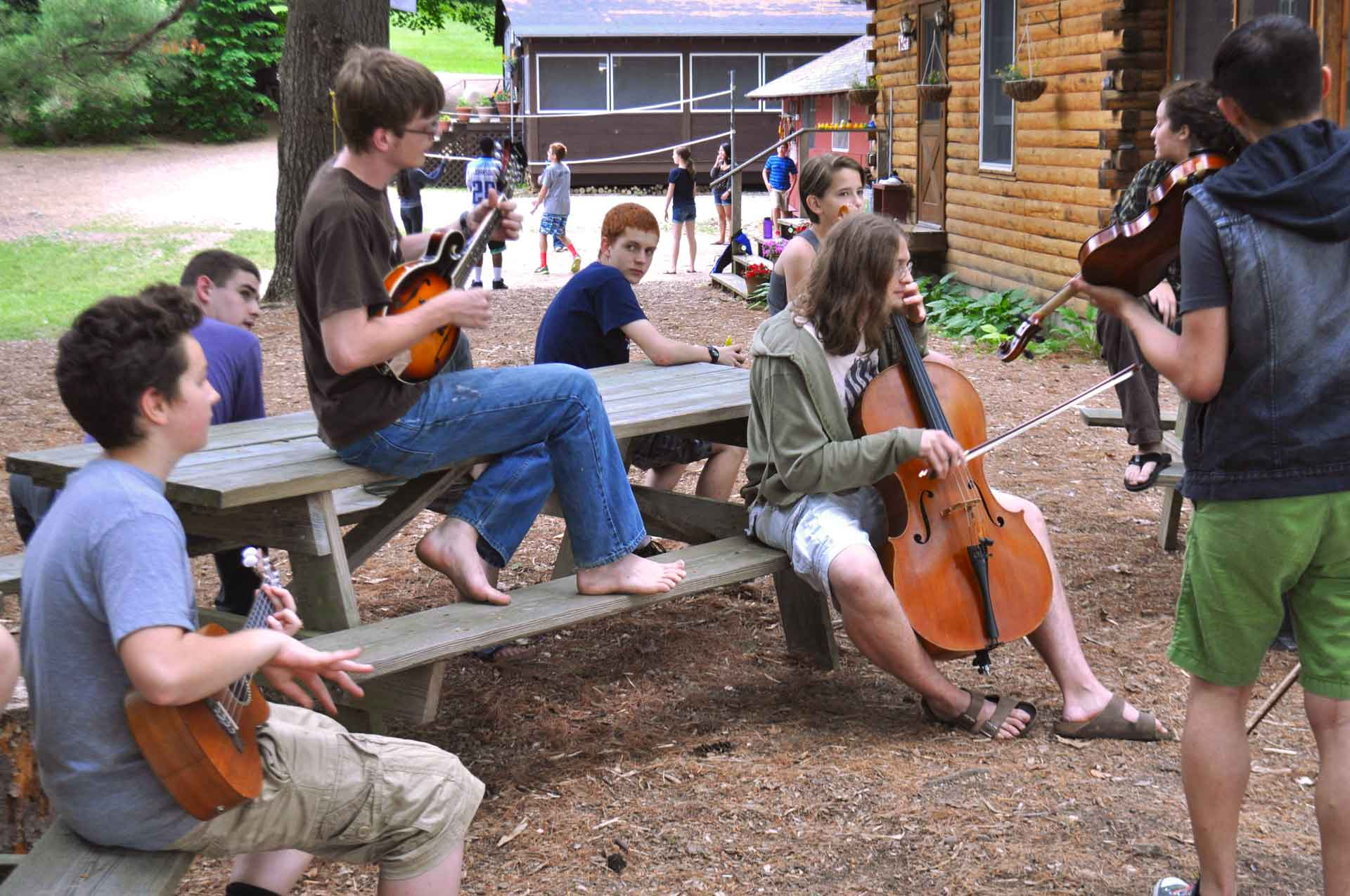 Point CounterPoint Foundation A group of people playing instruments in a lively Point CounterPoint, creating harmonious music together.